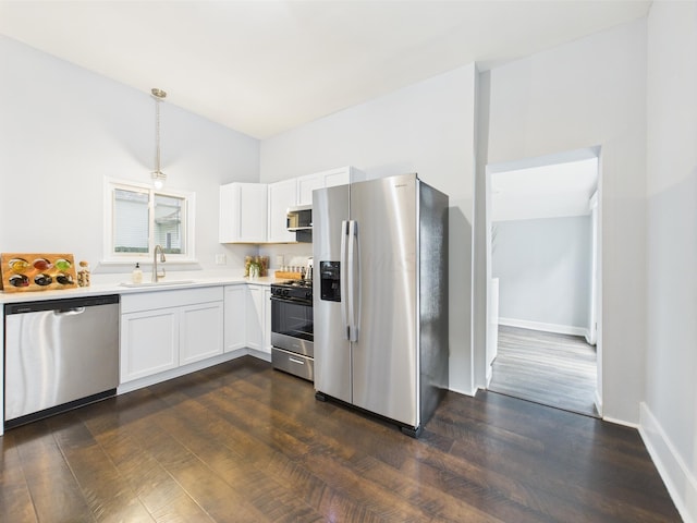715 N Broad St, Lancaster, OH 43130 - kitchen featuring stainless steel appliances, a sink, light countertops, white cabinetry, and hanging light fixtures