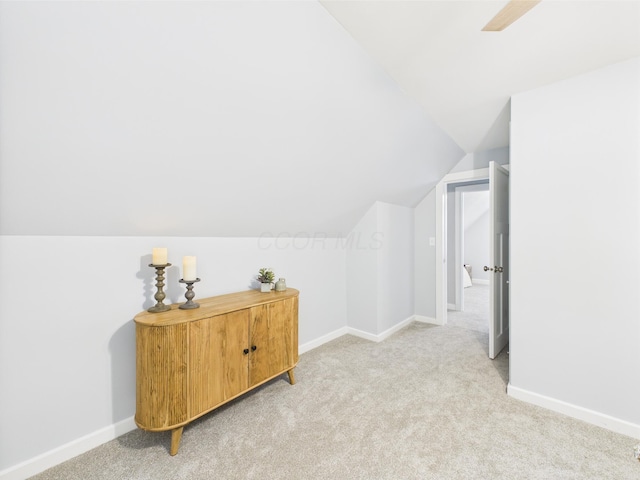 715 N Broad St, Lancaster, OH 43130 - additional living space with light carpet, vaulted ceiling, and baseboards