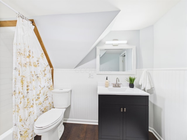 715 N Broad St, Lancaster, OH 43130 - bathroom featuring toilet, vanity, wood finished floors, vaulted ceiling, and shower / bath combination with curtain