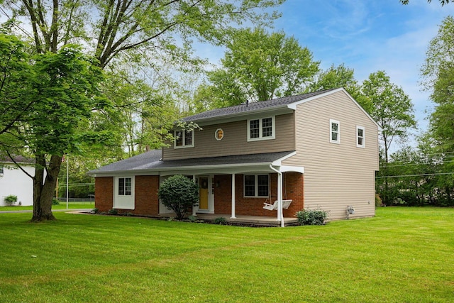 13789 Cobblestone Ln, Pickerington, OH 43147 - traditional home featuring covered porch, a front yard, brick siding, and a shingled roof