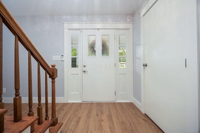 13789 Cobblestone Ln, Pickerington, OH 43147 - foyer entrance featuring stairway, light wood-style flooring, and baseboards