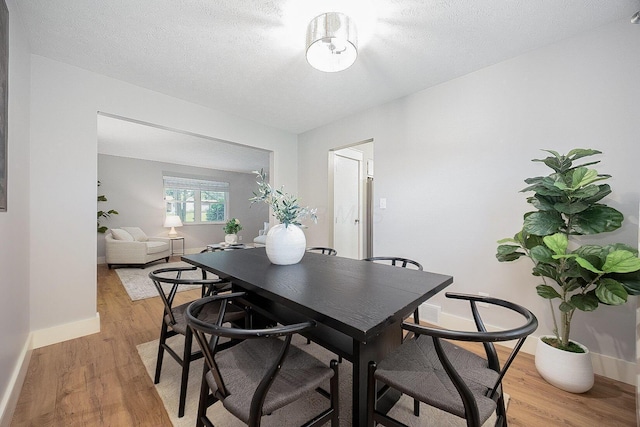 13789 Cobblestone Ln, Pickerington, OH 43147 - dining area with light wood-style floors, baseboards, and a textured ceiling