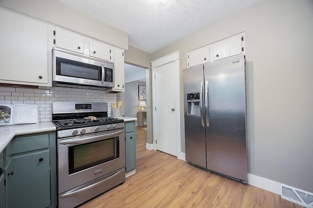 13789 Cobblestone Ln, Pickerington, OH 43147 - kitchen with appliances with stainless steel finishes, light countertops, white cabinetry, and a textured ceiling