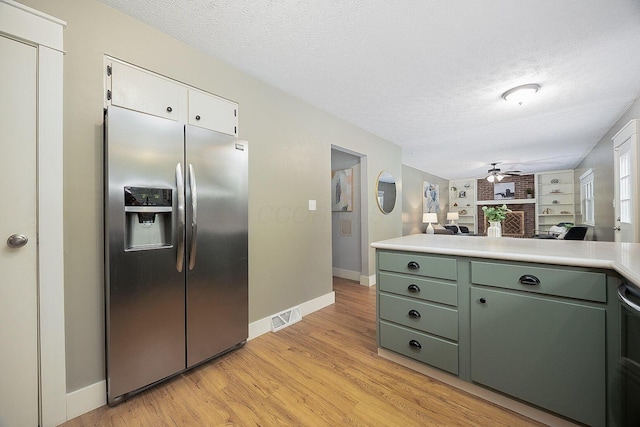 13789 Cobblestone Ln, Pickerington, OH 43147 - kitchen with stainless steel refrigerator with ice dispenser, a textured ceiling, green cabinets, light countertops, and baseboards