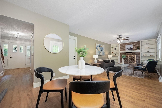 13789 Cobblestone Ln, Pickerington, OH 43147 - dining space featuring a textured ceiling, light wood-type flooring, a ceiling fan, and plenty of natural light