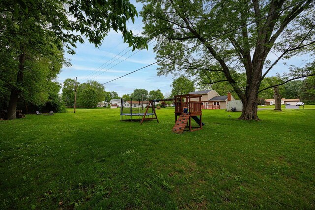 13789 Cobblestone Ln, Pickerington, OH 43147 - view of green lawn featuring a trampoline and a playground