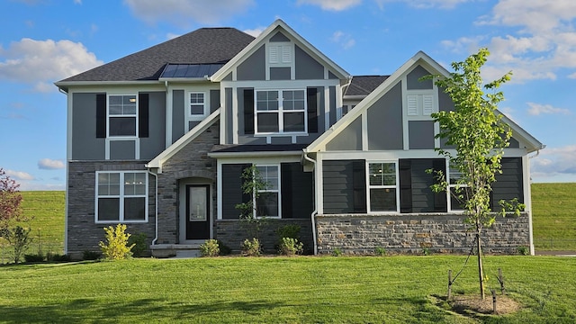 2497 Nelson Ln, Delaware, OH 43015 - view of front of home featuring stone siding, a front lawn, a shingled roof, and a standing seam roof
