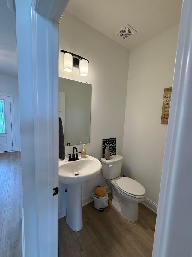 2497 Nelson Ln, Delaware, OH 43015 - half bath with wood finished floors, toilet, and baseboards