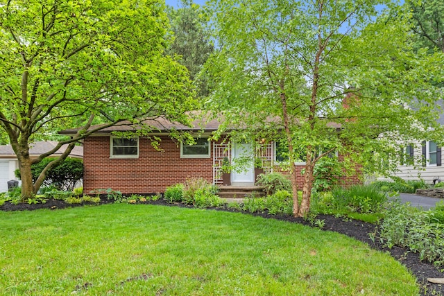 2629 Woodley Rd, Columbus, OH 43231 - view of front facade with a front lawn and brick siding
