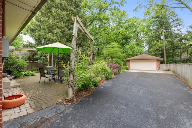 2629 Woodley Rd, Columbus, OH 43231 - view of patio / terrace with a detached garage and an outdoor structure
