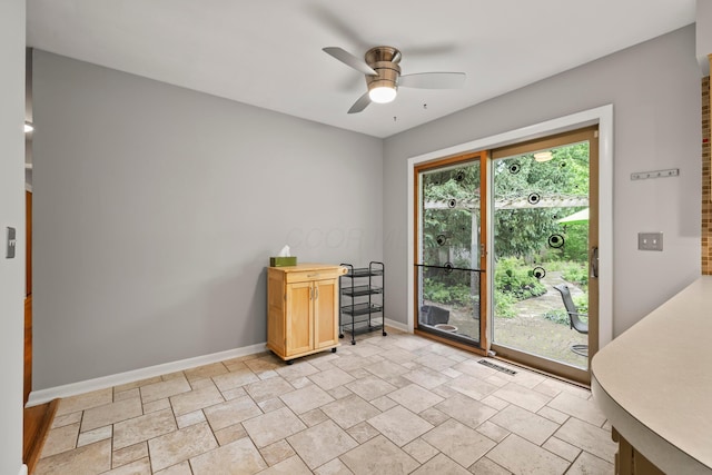 2629 Woodley Rd, Columbus, OH 43231 - spare room featuring a ceiling fan, baseboards, and light stone finish flooring