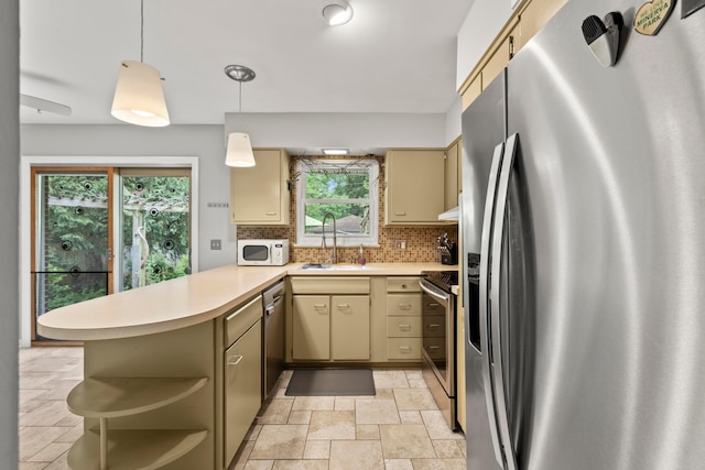 2629 Woodley Rd, Columbus, OH 43231 - kitchen with stainless steel appliances, cream cabinetry, a peninsula, light countertops, and open shelves