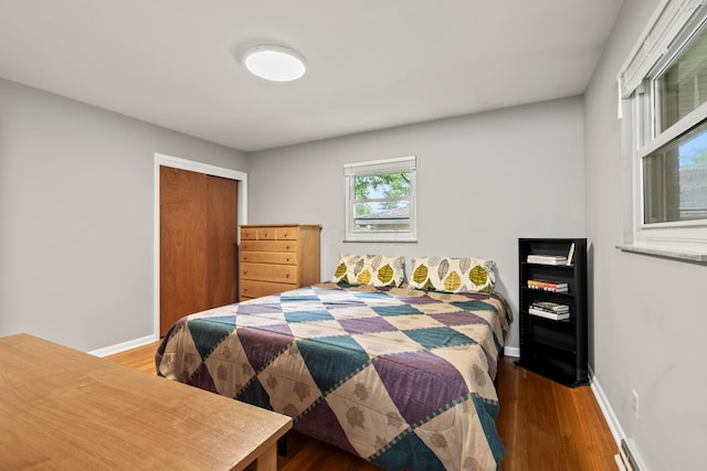 2629 Woodley Rd, Columbus, OH 43231 - bedroom with wood finished floors, baseboards, a closet, and a baseboard heating unit