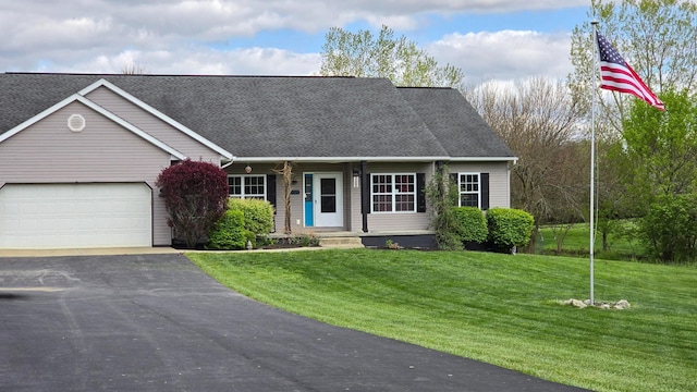 9148 Mccord Rd, Orient, OH 43146 - view of front of home with an attached garage, asphalt driveway, a front yard, roof with shingles, and a porch