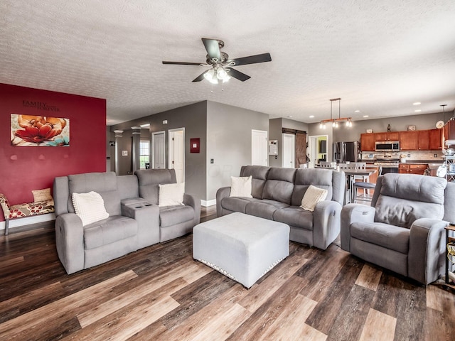 9148 Mccord Rd, Orient, OH 43146 - living area featuring dark wood-style floors, ceiling fan, a textured ceiling, and baseboards