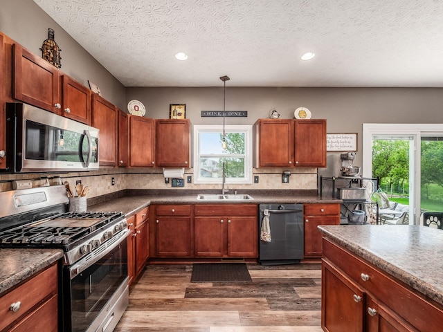 9148 Mccord Rd, Orient, OH 43146 - kitchen featuring appliances with stainless steel finishes, a sink, dark countertops, healthy amount of natural light, and recessed lighting