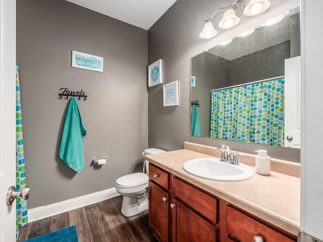9148 Mccord Rd, Orient, OH 43146 - full bath with wood finished floors, vanity, toilet, a shower with shower curtain, and baseboards