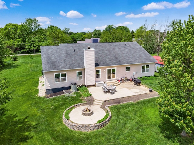 9148 Mccord Rd, Orient, OH 43146 - back of property with a fire pit, a patio, a chimney, and a lawn