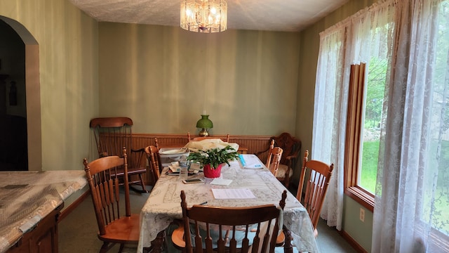 14780 Bellepoint Rd, Ostrander, OH 43061 - carpeted dining space featuring arched walkways and a chandelier