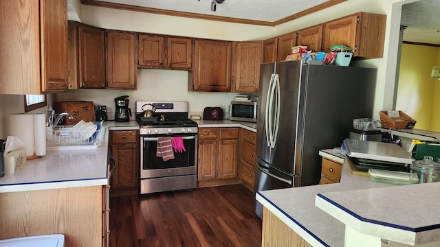 14780 Bellepoint Rd, Ostrander, OH 43061 - kitchen with stainless steel appliances, ornamental molding, light countertops, dark wood-style floors, and brown cabinetry