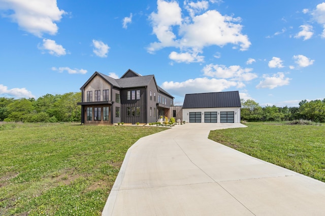 3318 S County Line Rd, Johnstown, OH 43031 - view of front of house with a detached garage, a front yard, an outbuilding, and metal roof