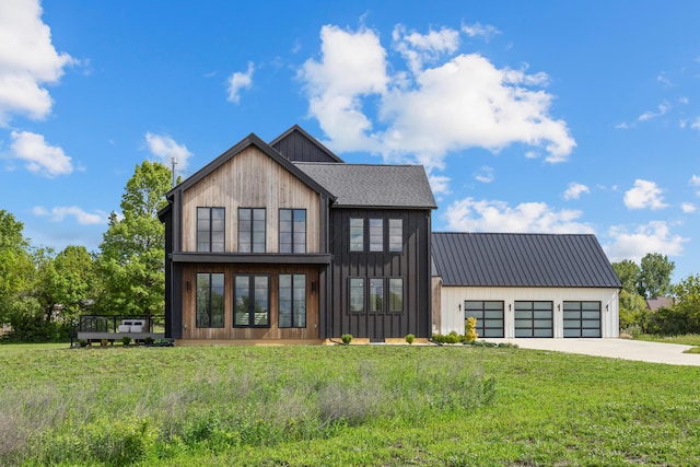 3318 S County Line Rd, Johnstown, OH 43031 - back of house with concrete driveway, an attached garage, a yard, metal roof, and a deck