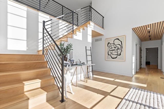 3318 S County Line Rd, Johnstown, OH 43031 - stairway featuring wood finished floors, a towering ceiling, and baseboards