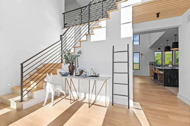 3318 S County Line Rd, Johnstown, OH 43031 - stairs with wood finished floors, a towering ceiling, and baseboards