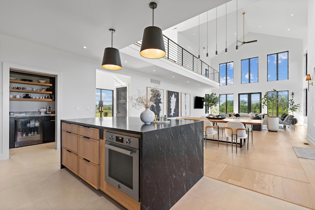 3318 S County Line Rd, Johnstown, OH 43031 - kitchen featuring wine cooler, open floor plan, stainless steel oven, modern cabinets, and a high ceiling