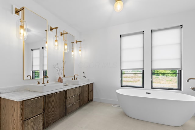 3318 S County Line Rd, Johnstown, OH 43031 - bathroom with double vanity, a freestanding tub, and baseboards