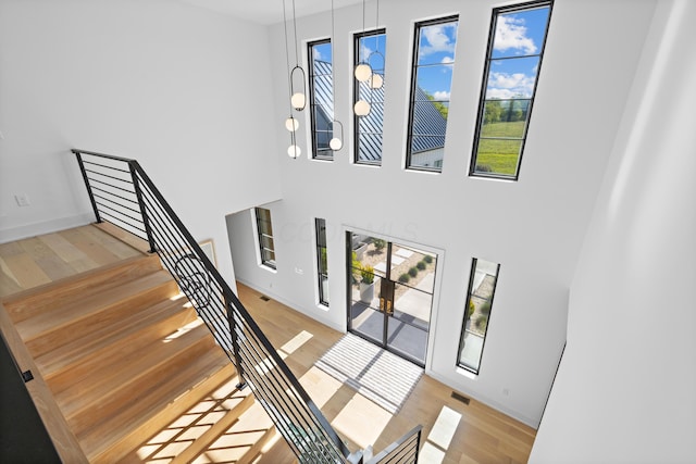 3318 S County Line Rd, Johnstown, OH 43031 - stairs with wood finished floors, baseboards, and a high ceiling