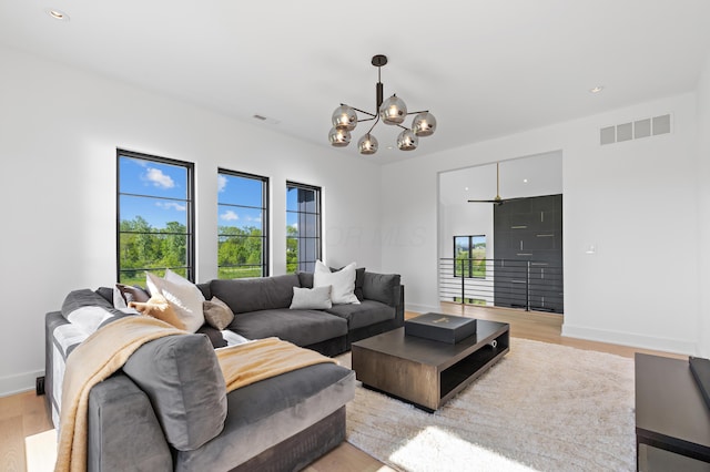 3318 S County Line Rd, Johnstown, OH 43031 - living room with healthy amount of natural light, a chandelier, light wood-style flooring, baseboards, and recessed lighting
