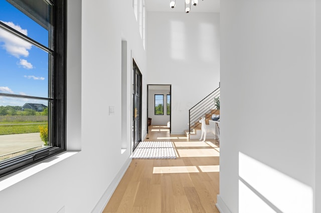 3318 S County Line Rd, Johnstown, OH 43031 - corridor featuring a towering ceiling, light wood-type flooring, stairway, and baseboards