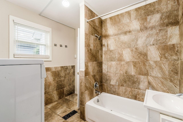 815 Hamlet St, Columbus, OH 43215 - full bathroom featuring tile walls, shower / bath combination, washer / clothes dryer, and vanity