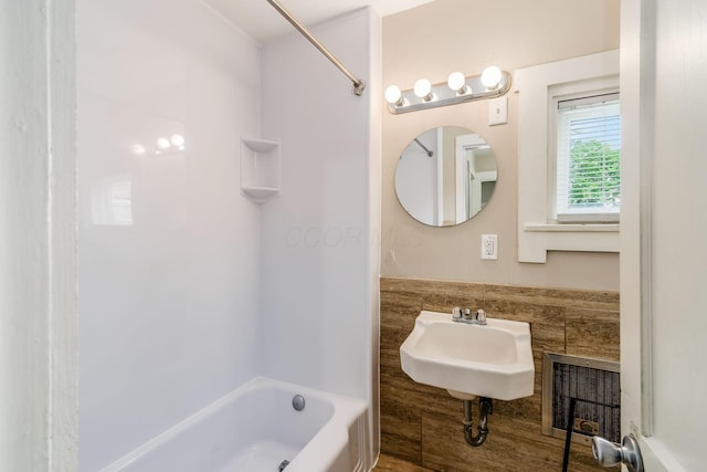 815 Hamlet St, Columbus, OH 43215 - bathroom featuring shower / bathtub combination, tile walls, ornamental molding, and a sink