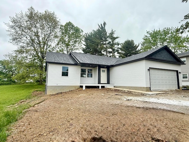 129 Hasbrouck Cir, Howard, OH 43028 - view of front facade featuring an attached garage, dirt driveway, and roof with shingles