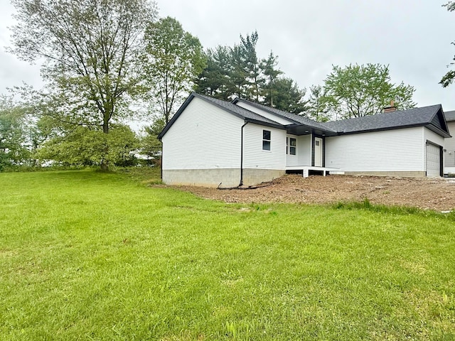 129 Hasbrouck Cir, Howard, OH 43028 - view of property exterior featuring an attached garage, a yard, and a chimney