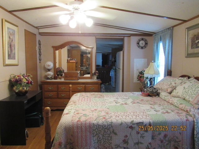 235 Parklawn Dr, Circleville, OH 43113 - bedroom with wood finished floors, freestanding refrigerator, lofted ceiling, ornamental molding, and ceiling fan