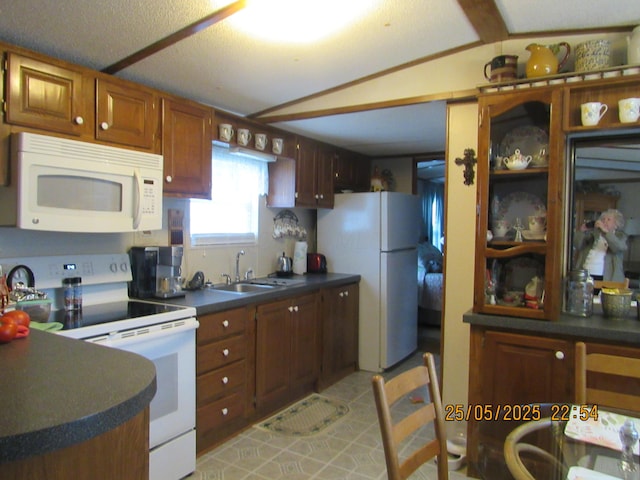 235 Parklawn Dr, Circleville, OH 43113 - kitchen featuring white appliances, a sink, dark countertops, and brown cabinetry