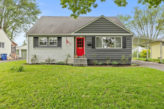 1296 Bryson Rd, Columbus, OH 43224 - view of front of house with driveway, a front lawn, a carport, and entry steps