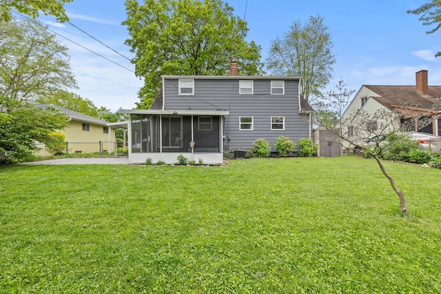 1296 Bryson Rd, Columbus, OH 43224 - rear view of property featuring a sunroom, a chimney, and central AC unit