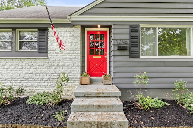 1296 Bryson Rd, Columbus, OH 43224 - view of exterior entry featuring brick siding