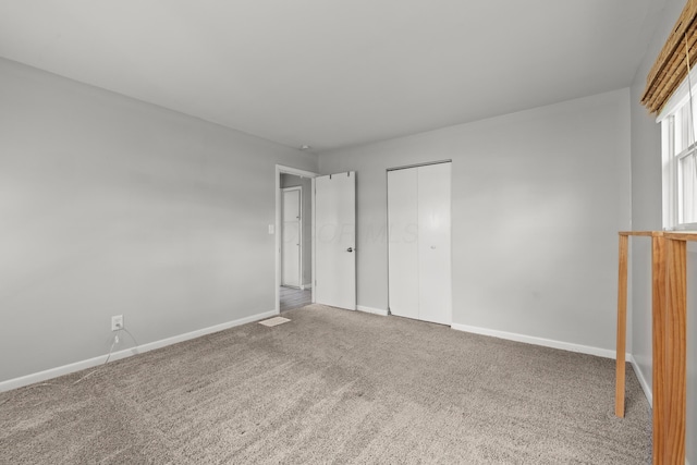 1296 Bryson Rd, Columbus, OH 43224 - unfurnished bedroom featuring carpet floors, baseboards, and a closet