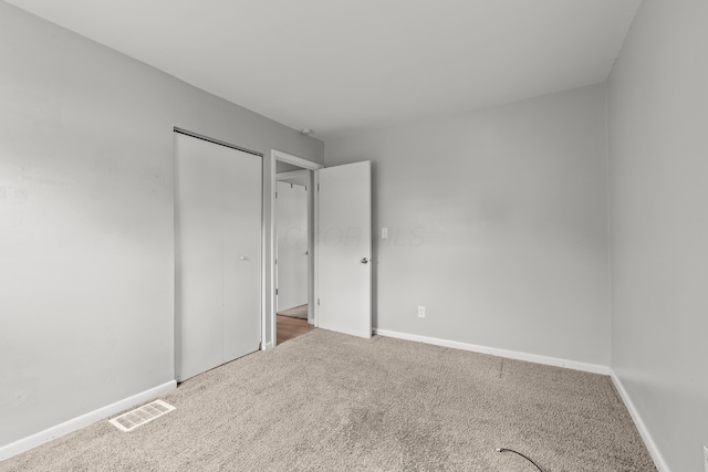 1296 Bryson Rd, Columbus, OH 43224 - unfurnished bedroom featuring carpet flooring, baseboards, and a closet