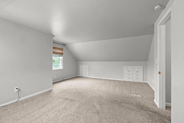 1296 Bryson Rd, Columbus, OH 43224 - additional living space with baseboards, vaulted ceiling, and carpet flooring