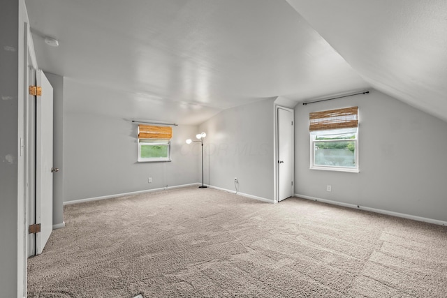 1296 Bryson Rd, Columbus, OH 43224 - additional living space featuring carpet floors, vaulted ceiling, and baseboards