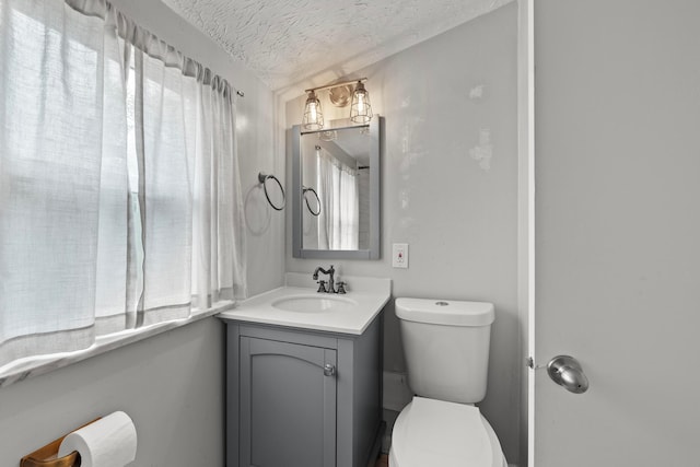 1296 Bryson Rd, Columbus, OH 43224 - half bathroom with a textured ceiling, vanity, and toilet