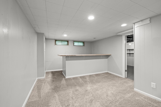 1296 Bryson Rd, Columbus, OH 43224 - below grade area with carpet floors, a bar, recessed lighting, and baseboards