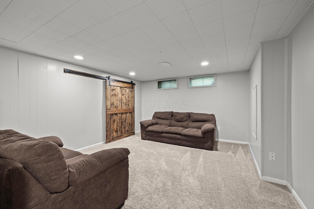 1296 Bryson Rd, Columbus, OH 43224 - living room with a barn door, carpet flooring, a decorative wall, and recessed lighting