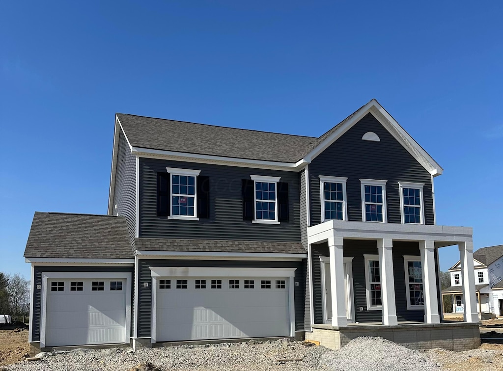 7296 Coralberry Way, Plain City, OH 43064 - view of front of house with a porch, driveway, and a shingled roof